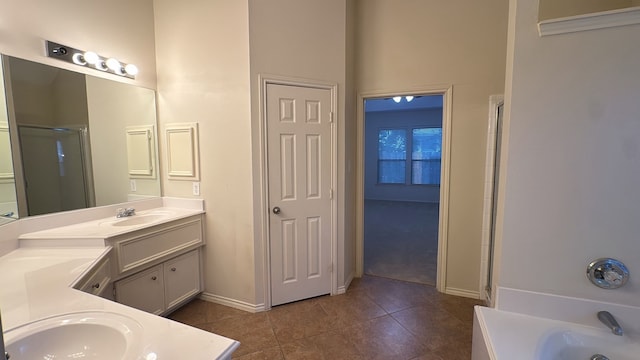 4923 Lake Gladewater Ct, Richmond, TX 77407 - bathroom with tile patterned floors, a shower with door, baseboards, vanity, and a tub to relax in