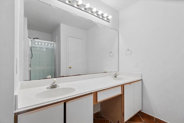 bathroom with tile patterned flooring, a sink, double vanity, and a stall shower