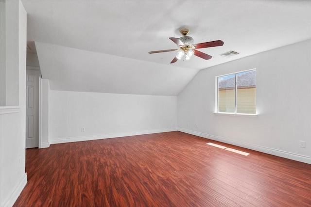 additional living space featuring baseboards, a ceiling fan, wood finished floors, and visible vents