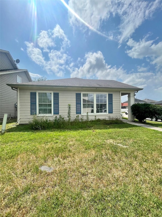 view of front of property featuring concrete driveway and a front lawn