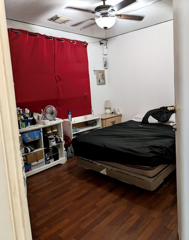 bedroom featuring visible vents, ceiling fan, and wood finished floors