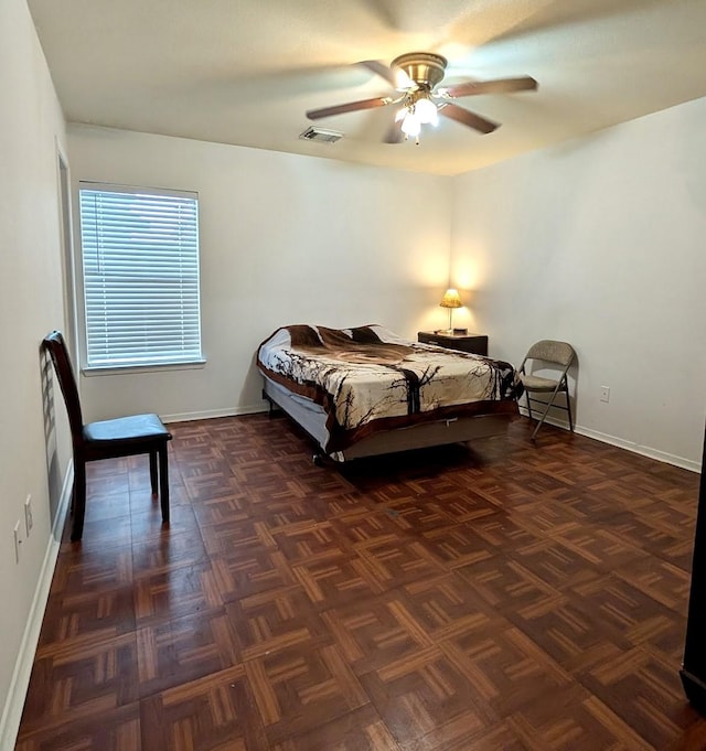 bedroom with visible vents, baseboards, and ceiling fan