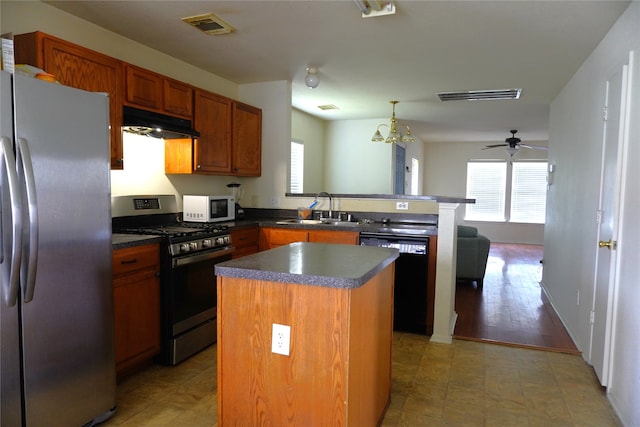 1120 Verde Trails Dr, Houston, TX 77073 - kitchen featuring stainless steel appliances, under cabinet range hood, a peninsula, and plenty of natural light