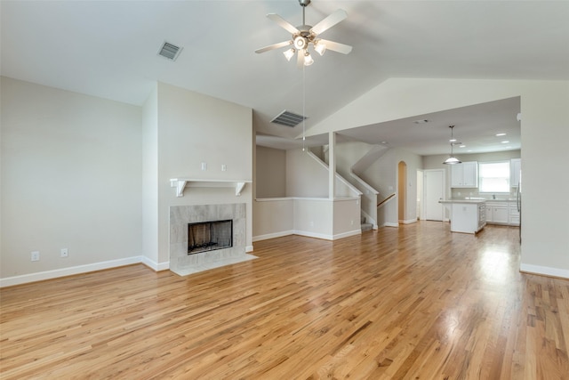 unfurnished living room with light wood finished floors, visible vents, and ceiling fan