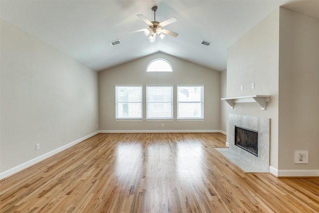 unfurnished living room with visible vents, ceiling fan, light wood-style flooring, and a fireplace