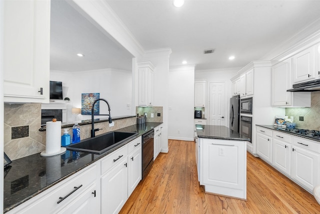 kitchen featuring under cabinet range hood, backsplash, a sink, and black appliances