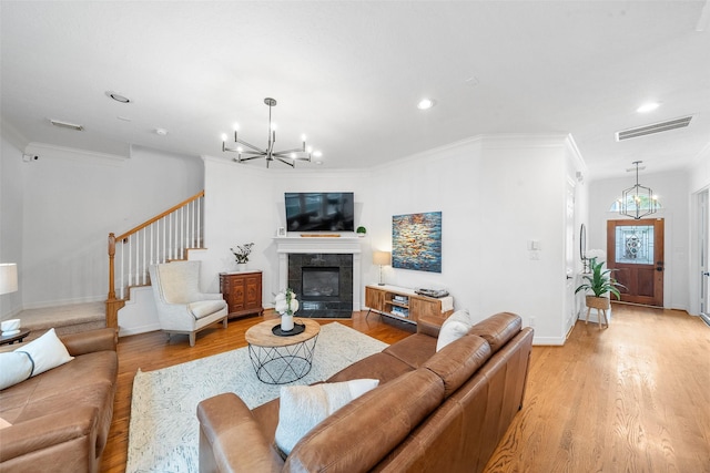 living room with visible vents, stairway, light wood finished floors, a chandelier, and recessed lighting