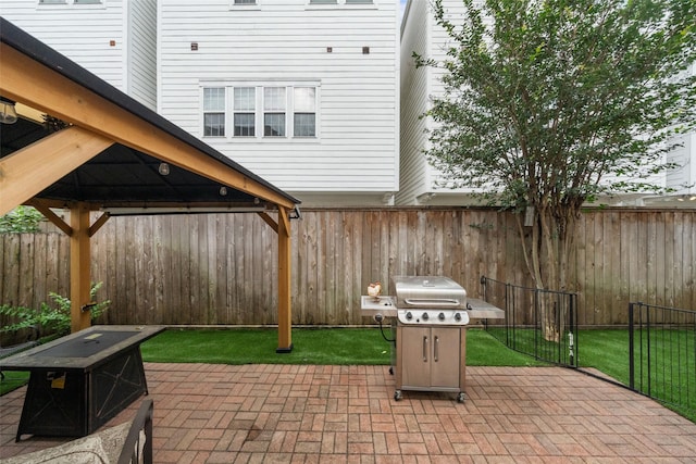 view of patio / terrace with a gazebo, a fenced backyard, and a grill