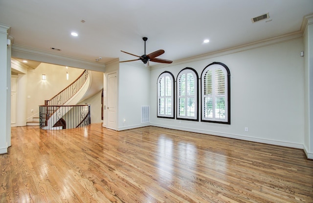unfurnished living room featuring ceiling fan, wood finished floors, and visible vents