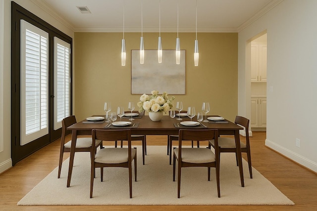 dining space featuring baseboards, crown molding, wood finished floors, and plenty of natural light