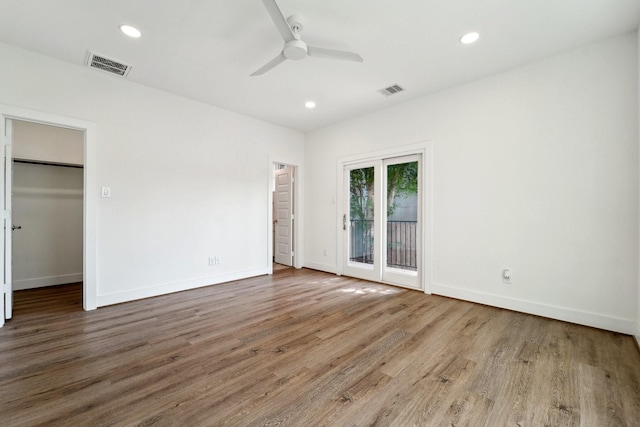 2520 Ohsfeldt St, Houston, TX 77008 - unfurnished bedroom with access to exterior, wood finished floors, baseboards, recessed lighting, and a spacious closet