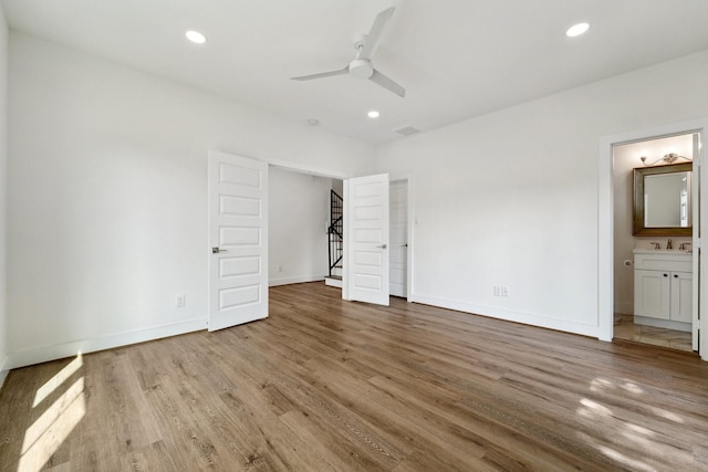 2520 Ohsfeldt St, Houston, TX 77008 - unfurnished bedroom with wood finished floors, baseboards, recessed lighting, a sink, and ensuite bath