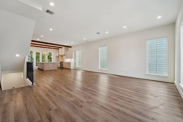 2520 Ohsfeldt St, Houston, TX 77008 - unfurnished living room with light wood-style floors, recessed lighting, and baseboards