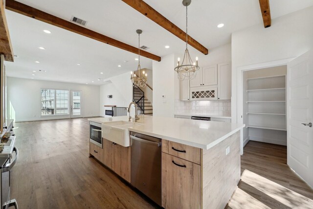2520 Ohsfeldt St, Houston, TX 77008 - kitchen featuring appliances with stainless steel finishes, a sink, wood finished floors, beam ceiling, and a chandelier