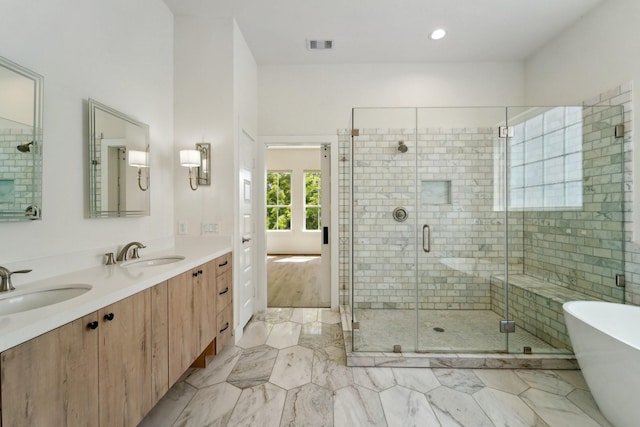 2520 Ohsfeldt St, Houston, TX 77008 - bathroom with a freestanding bath, double vanity, a stall shower, and marble finish flooring