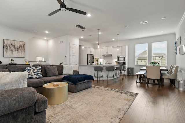 living room featuring visible vents, recessed lighting, dark wood finished floors, and a ceiling fan