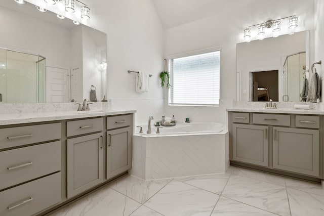 full bathroom featuring a garden tub, a sink, lofted ceiling, and a shower stall