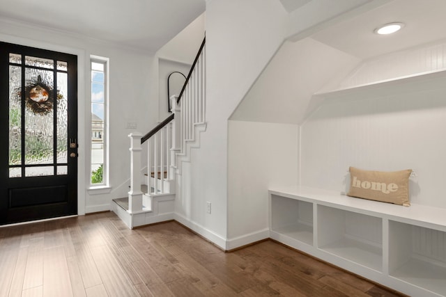 entrance foyer with plenty of natural light, baseboards, wood finished floors, and stairway