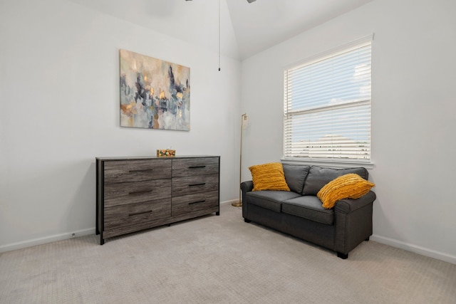 sitting room with baseboards, ceiling fan, and light carpet