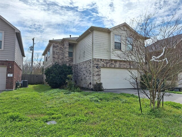 211 Sea Breeze Dr, Bacliff, TX 77518 - view of property exterior with fence, a yard, driveway, brick siding, and a garage