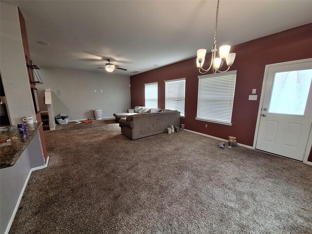 211 Sea Breeze Dr, Bacliff, TX 77518 - living room featuring ceiling fan with notable chandelier, plenty of natural light, baseboards, and carpet flooring