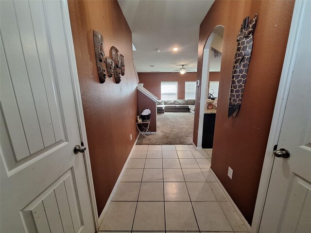 211 Sea Breeze Dr, Bacliff, TX 77518 - hallway featuring arched walkways, baseboards, light carpet, and light tile patterned floors