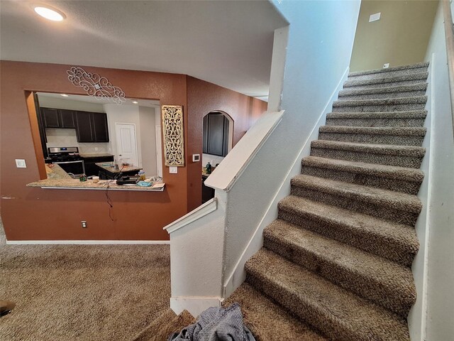 211 Sea Breeze Dr, Bacliff, TX 77518 - staircase featuring baseboards and carpet floors