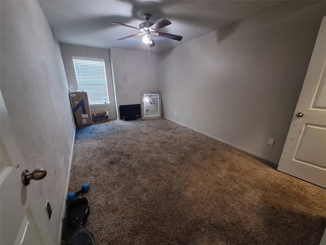 211 Sea Breeze Dr, Bacliff, TX 77518 - unfurnished living room with carpet flooring, baseboards, and ceiling fan
