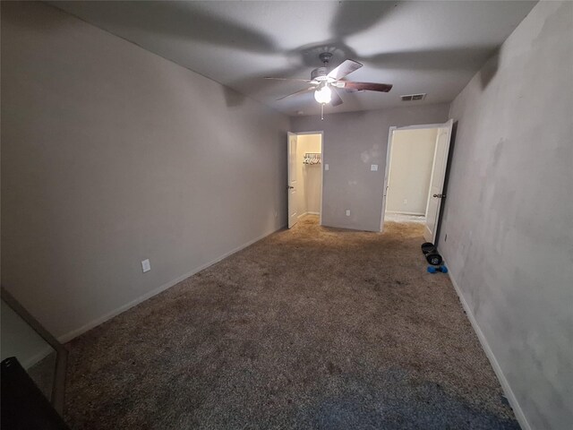 211 Sea Breeze Dr, Bacliff, TX 77518 - unfurnished bedroom featuring a ceiling fan, a spacious closet, carpet, baseboards, and visible vents
