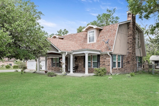 view of front of house featuring brick siding, a front yard, a gambrel roof, and a chimney