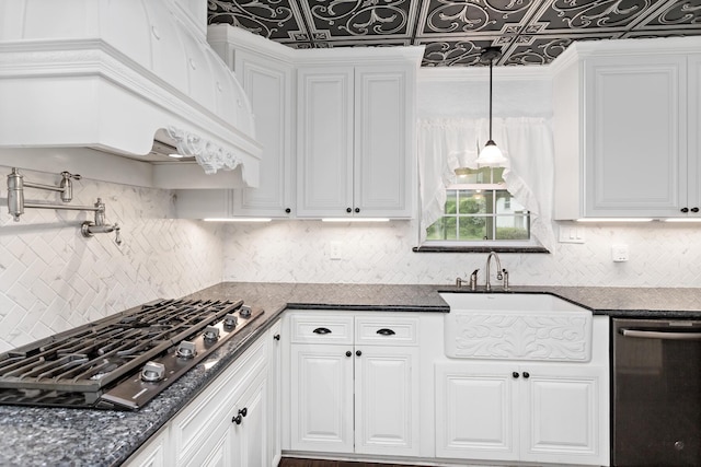 kitchen featuring white cabinets, stainless steel dishwasher, a sink, gas cooktop, and decorative backsplash