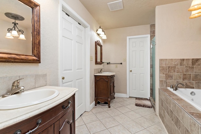 bathroom with a shower stall, a garden tub, a sink, tile patterned flooring, and visible vents
