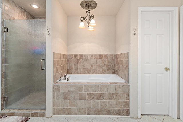 full bathroom featuring a bath, a shower stall, and tile patterned flooring