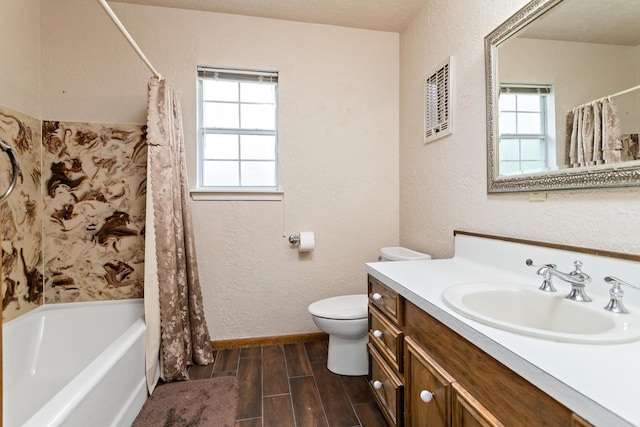 full bathroom with a textured wall, wood tiled floor, vanity, and toilet