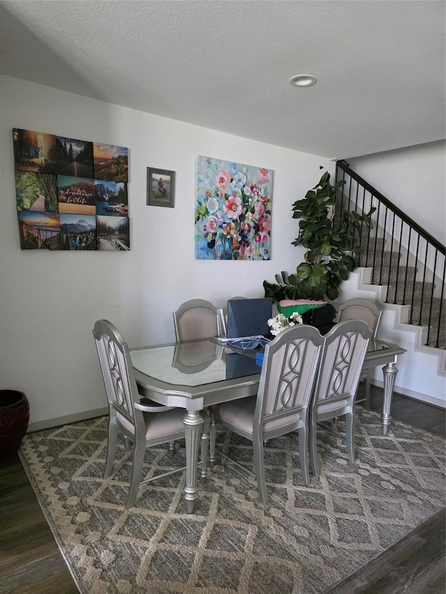 dining room with baseboards, wood finished floors, stairs, and recessed lighting