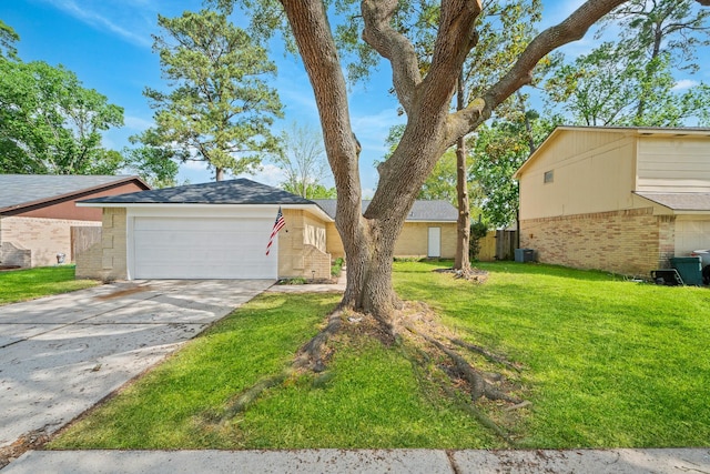 view of front of house with a front lawn, cooling unit, an attached garage, driveway, and brick siding