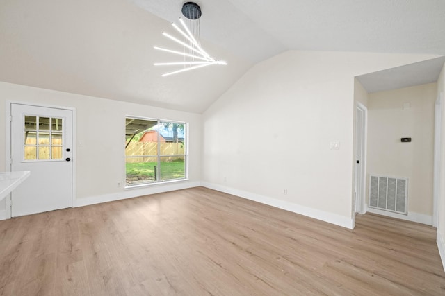 unfurnished living room with vaulted ceiling, baseboards, visible vents, light wood-style floors, and a notable chandelier