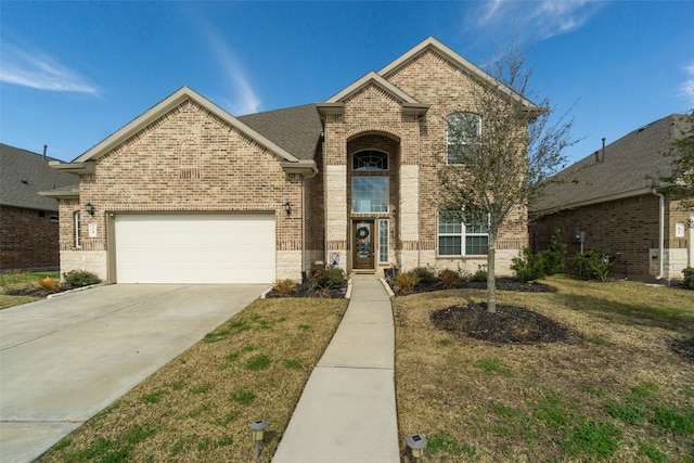 traditional-style house with a front lawn, driveway, brick siding, and a garage