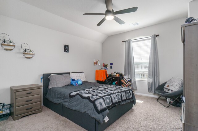 bedroom with vaulted ceiling, visible vents, baseboards, light colored carpet, and ceiling fan