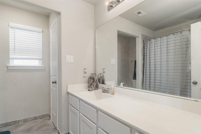 full bath with baseboards, vanity, tile patterned floors, and visible vents