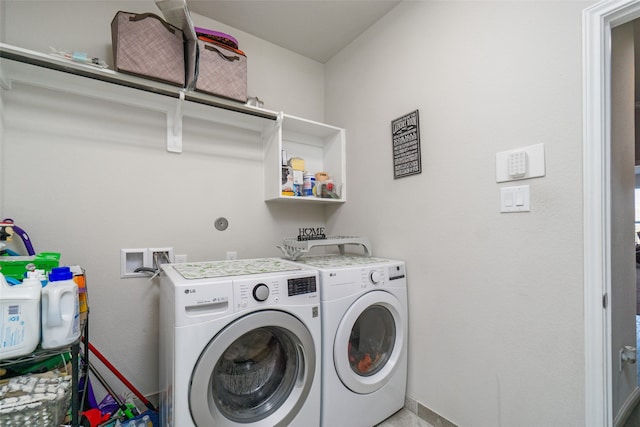 clothes washing area with separate washer and dryer and laundry area