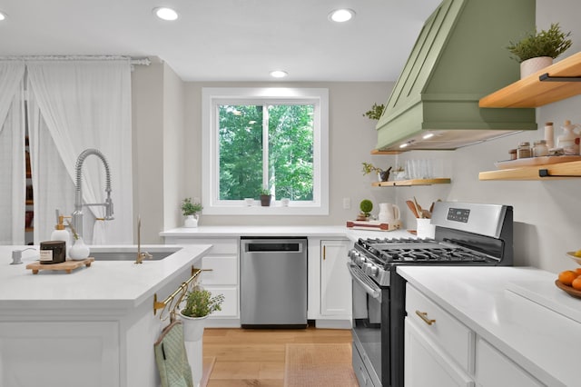 kitchen featuring open shelves, stainless steel appliances, custom exhaust hood, and recessed lighting