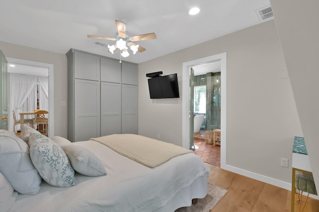 bedroom featuring light wood finished floors, baseboards, visible vents, a closet, and ceiling fan