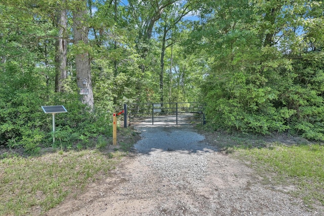 view of road with a gate and a forest view