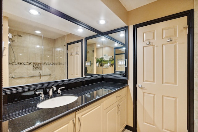 full bathroom with a stall shower, recessed lighting, and vanity