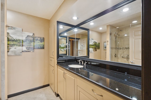 full bathroom with vanity, recessed lighting, a stall shower, and baseboards