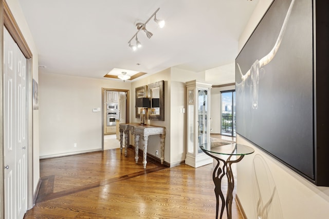 kitchen featuring appliances with stainless steel finishes, light wood-type flooring, and baseboards