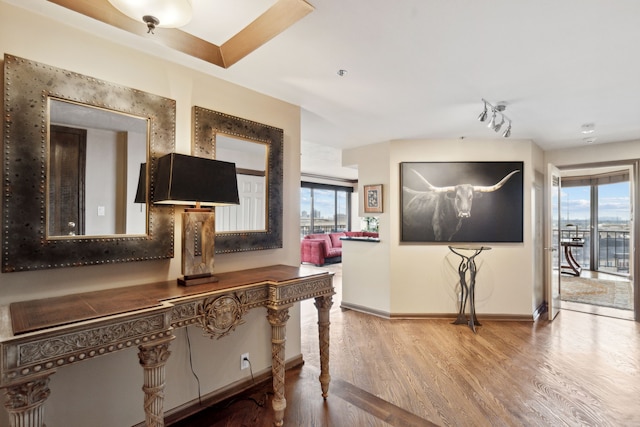 hall with wood finished floors and baseboards