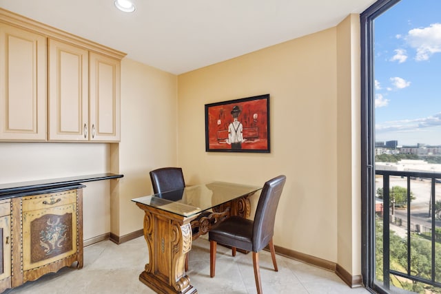 office featuring light tile patterned flooring, expansive windows, recessed lighting, and baseboards