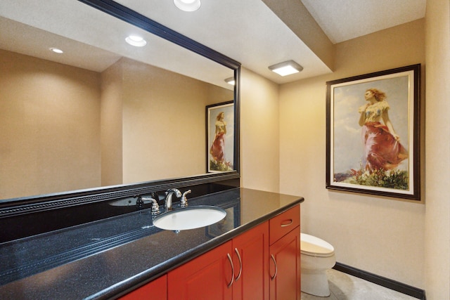 bathroom featuring vanity, toilet, recessed lighting, and baseboards